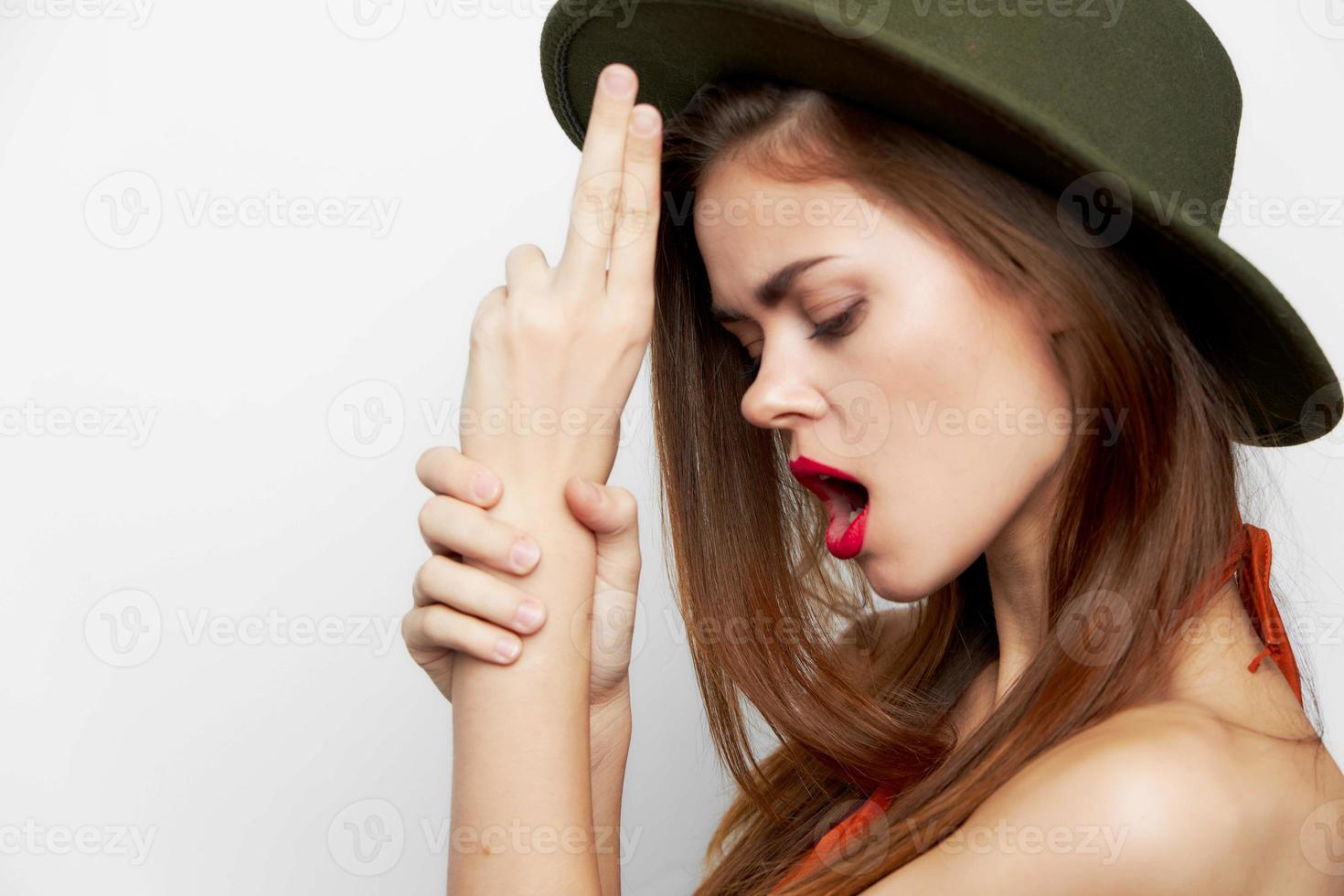 Portrait of a woman in a hat Look down fingers in the form of a pistol photo