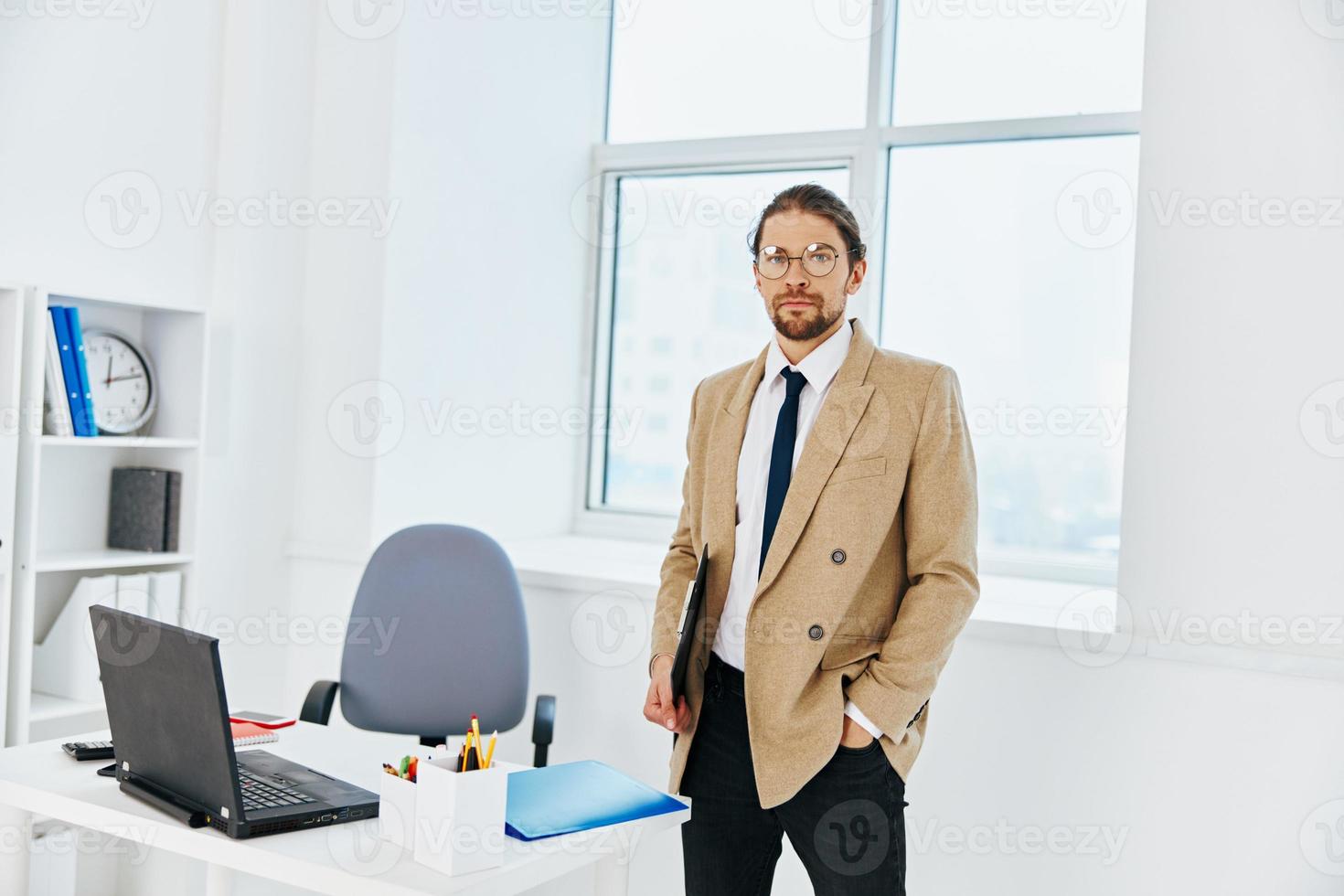 man in beige jacket holding a phone telephone office executive photo