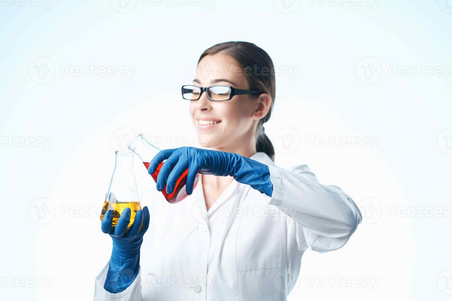 cheerful woman in a white coat analysis chemistry experiments photo