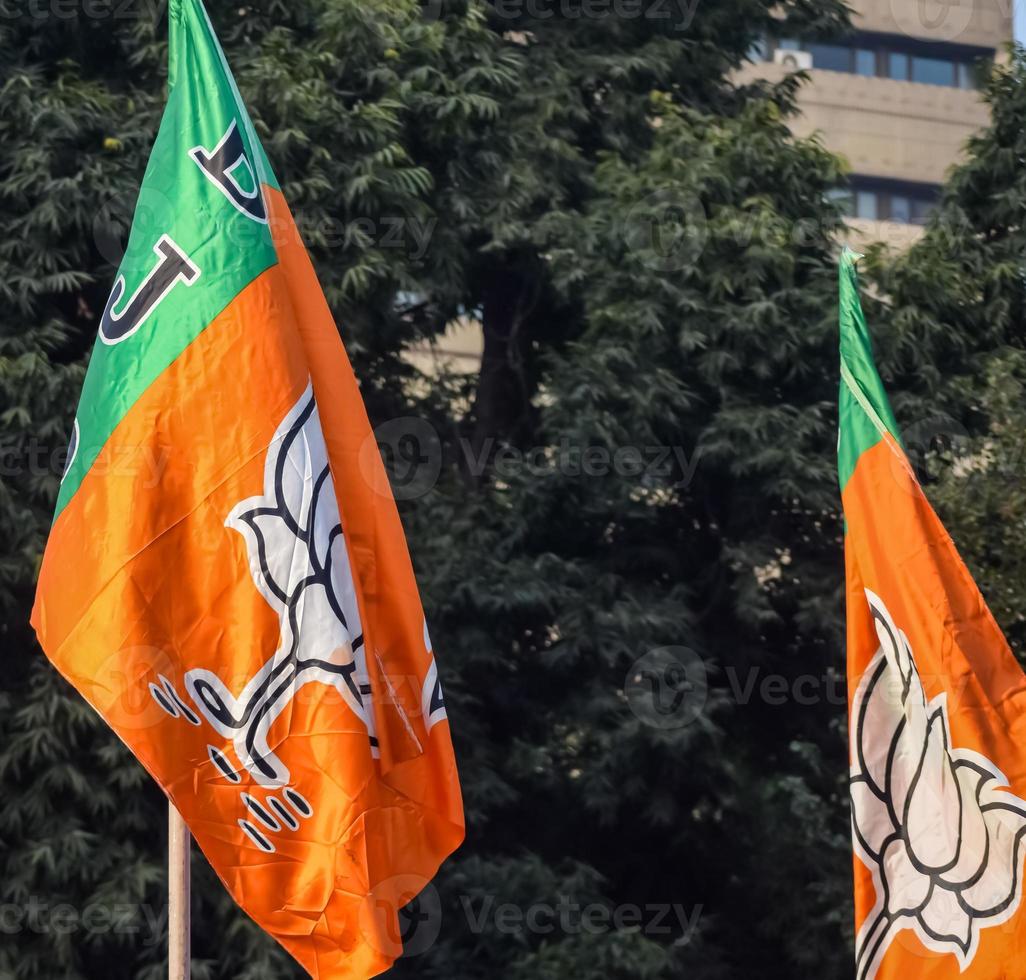 Bharatiya Janata Party Flag of Indian political party, BJP Bhartiya Janta Party Flag Waving during PM road show in Delhi, India photo