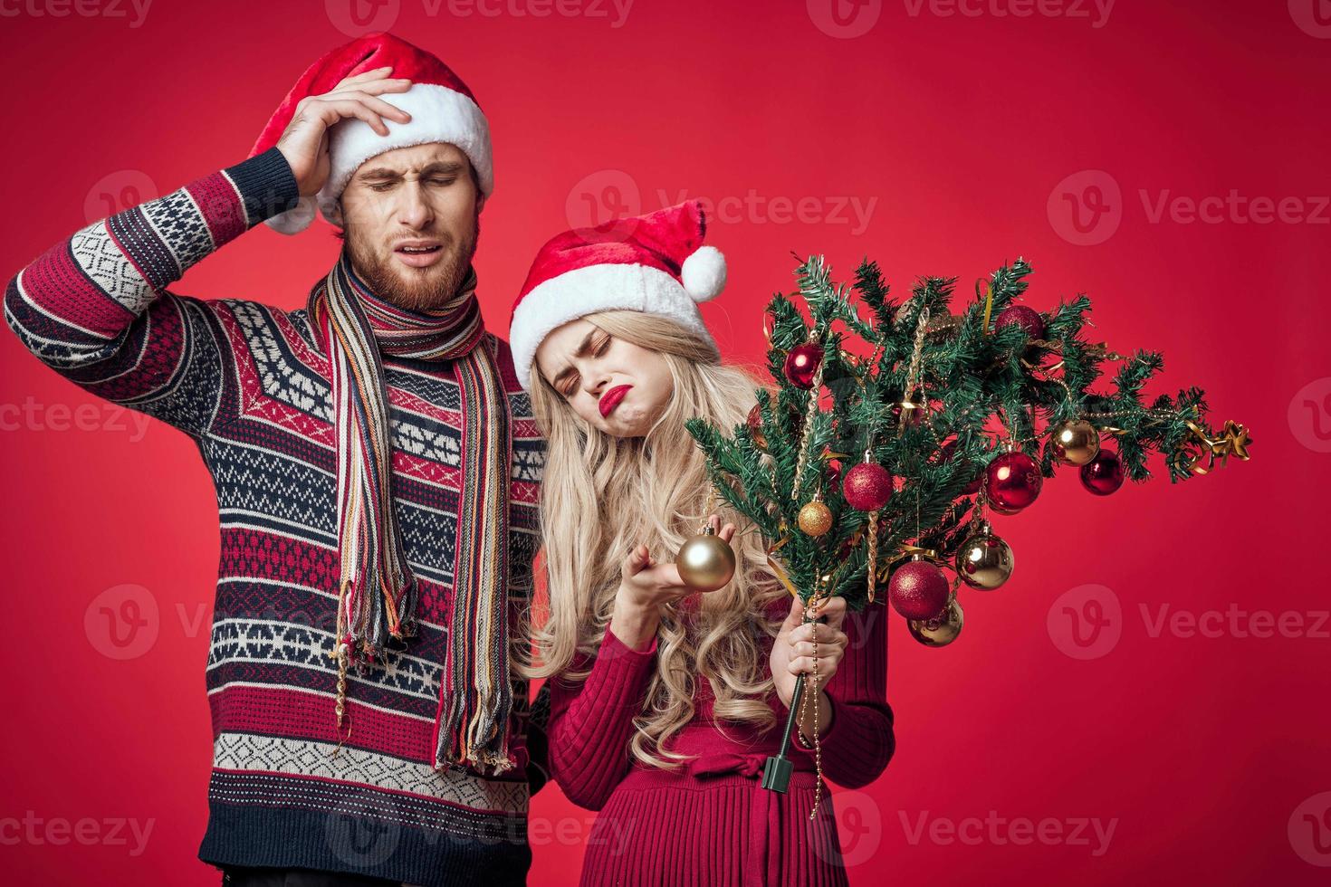 young couple celebrate christmas together decoration red background photo