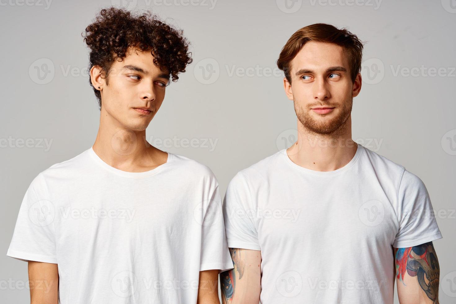 two men in white t-shirts are standing next to friendship emotions photo