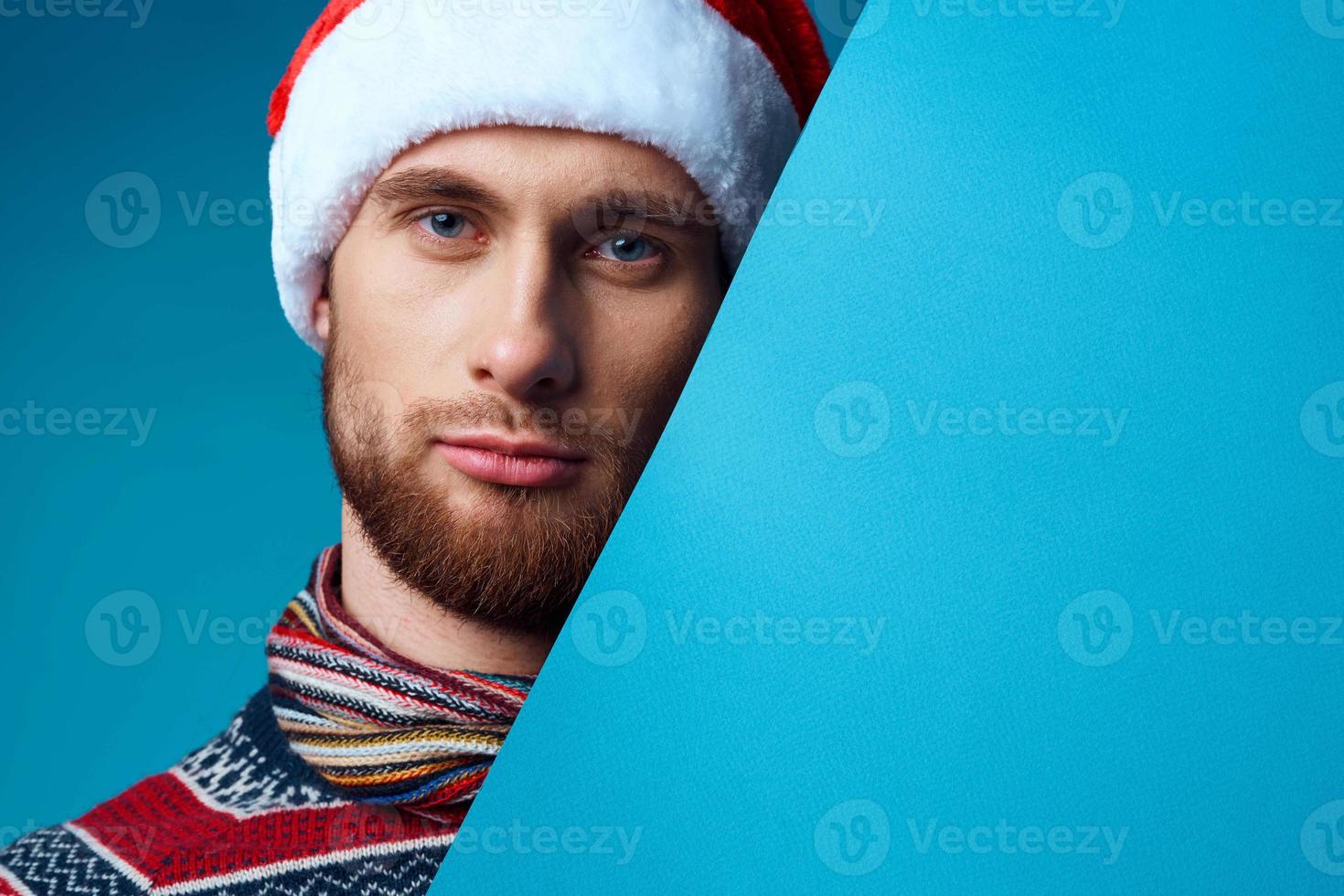 handsome man in New Year's clothes advertising copy space blue background photo