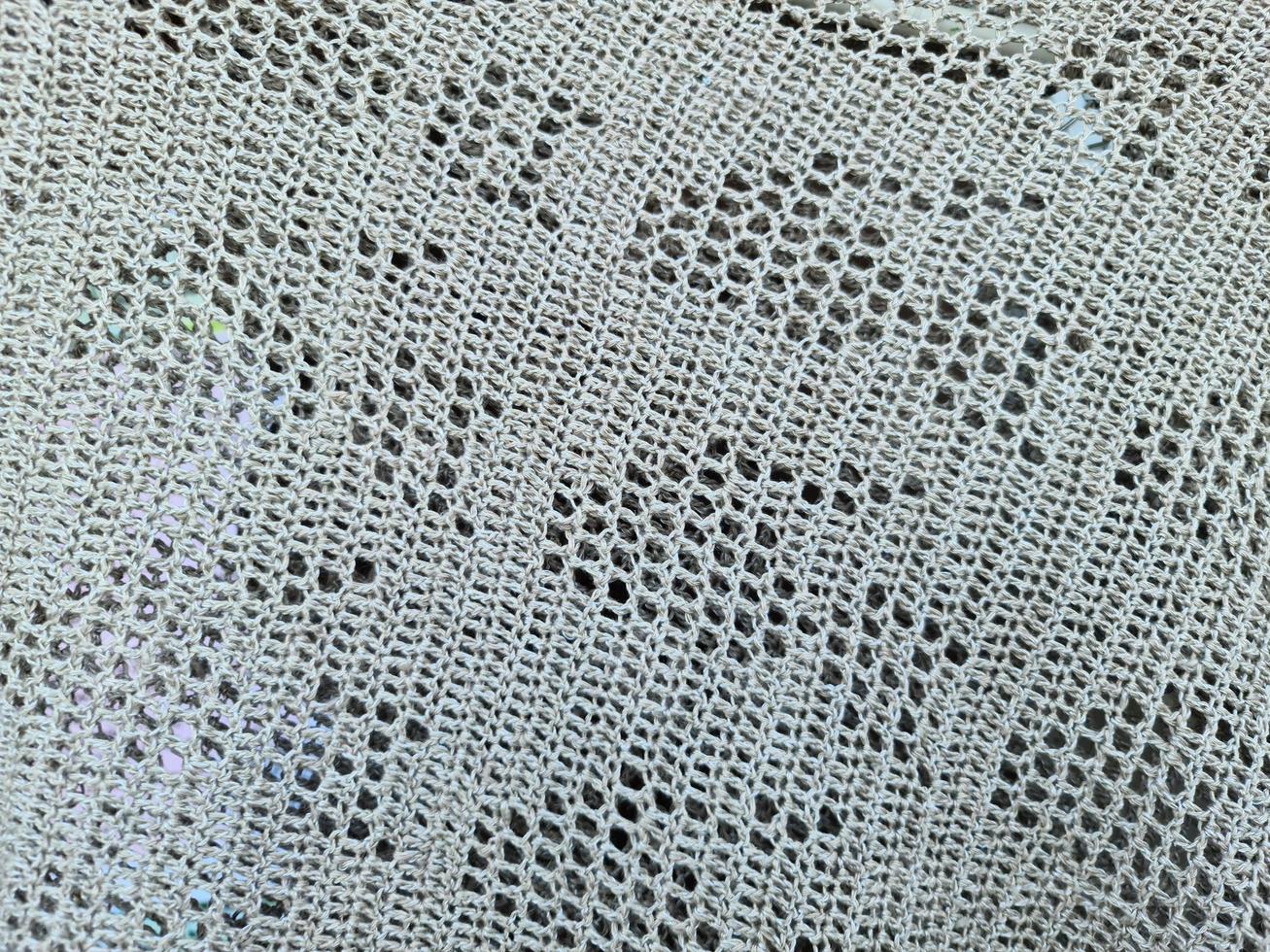 The texture of an openwork gray woolen shawl. photo