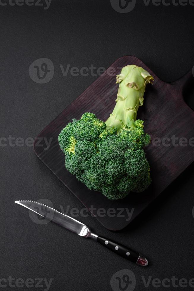 Raw fresh broccoli on a black home kitchen table photo