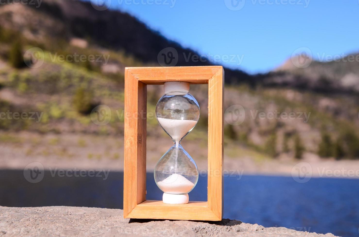 Sandglass on a rock photo