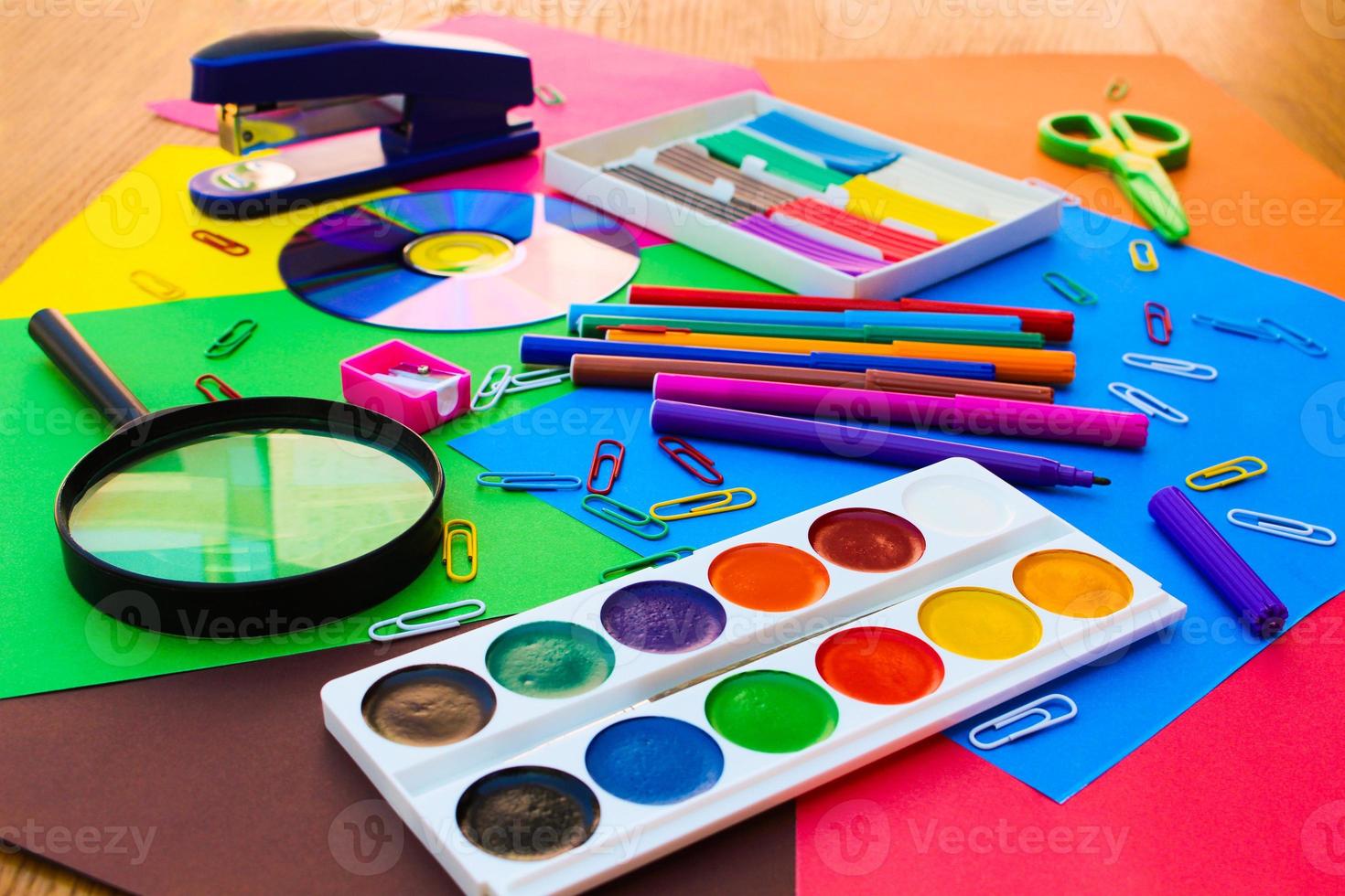 Stationery objects. School and office supplies on the background of colored paper. photo