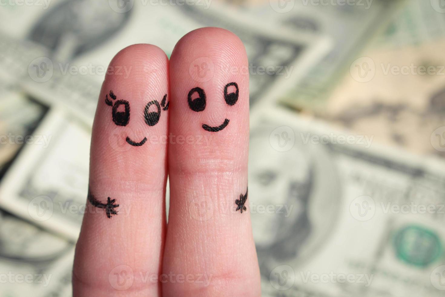 Finger art of a Happy couple hug on background of money. photo