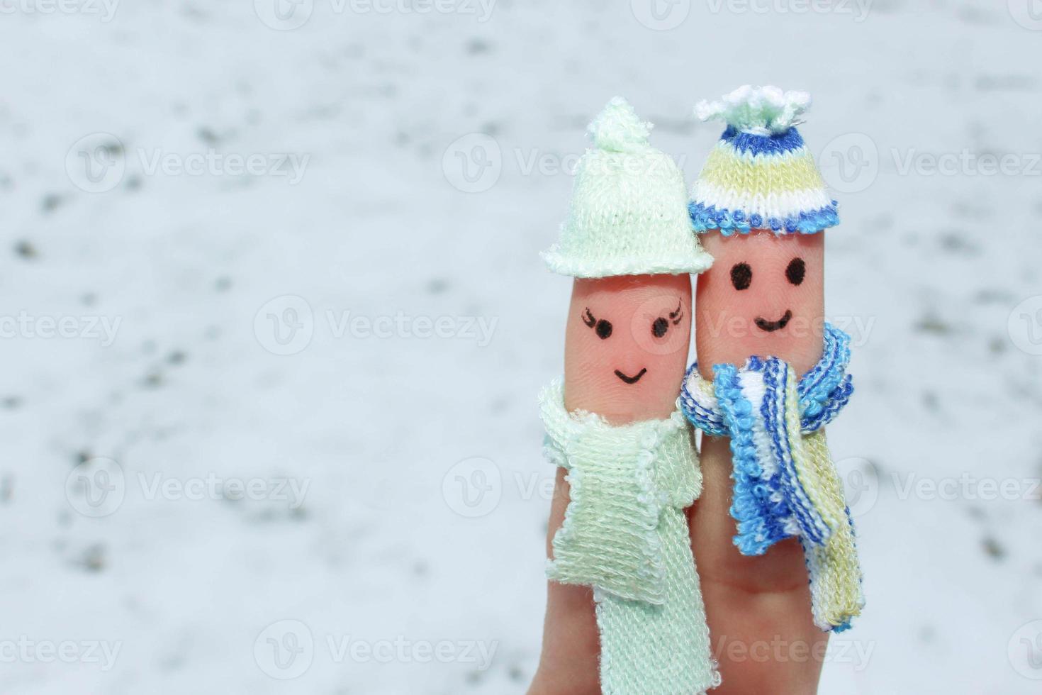 Finger art of a Happy couple on the background of snow. A man and a woman hug. photo