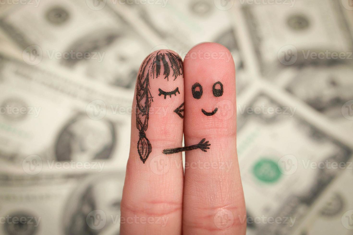 Girl kisses boy on the cheek on the background of money. photo