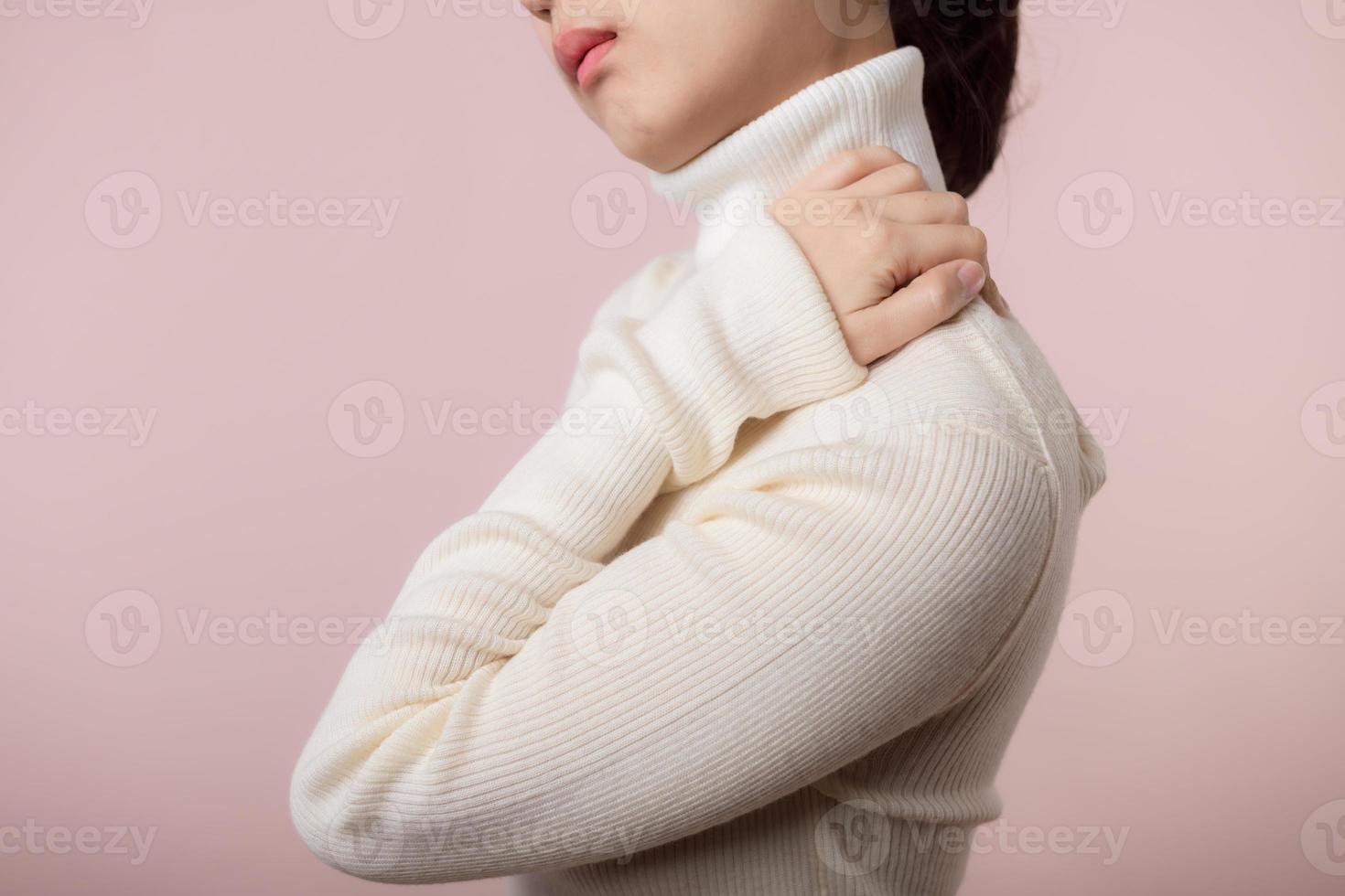 Asian young woman hold her hand on pain neck and injury ache shoulder stress problem muscle. Office syndrome disease, healthcare concept photo