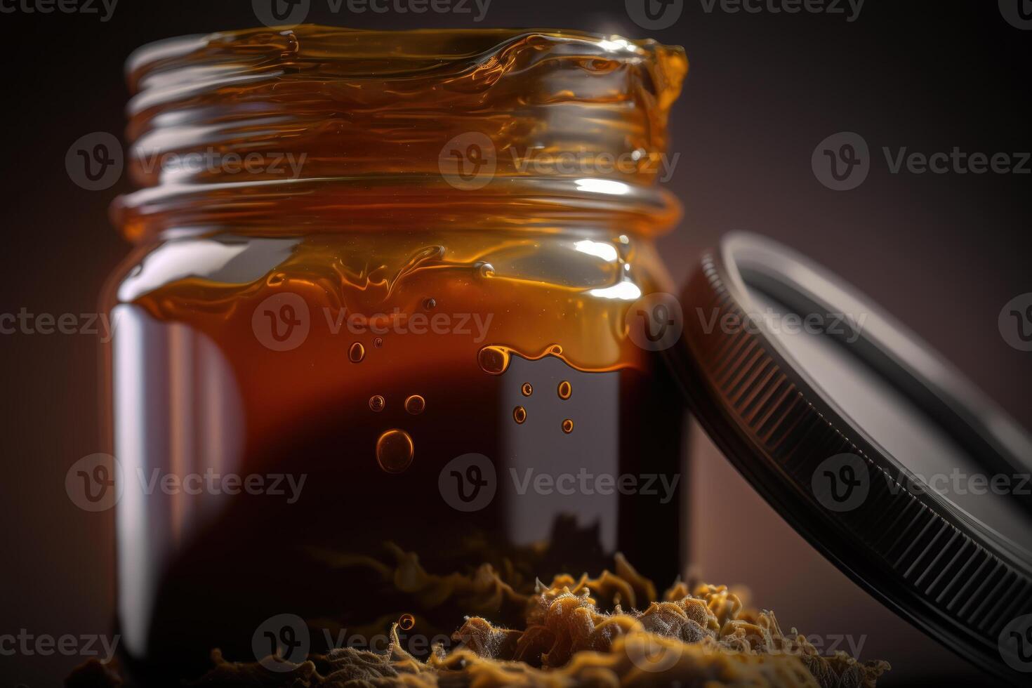 cannabis golden resin wax on jar photo