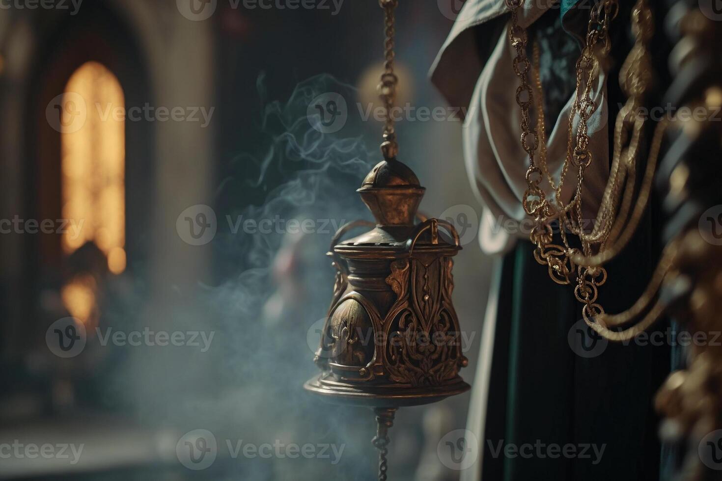 censer hanging on chains with incense smoking photo