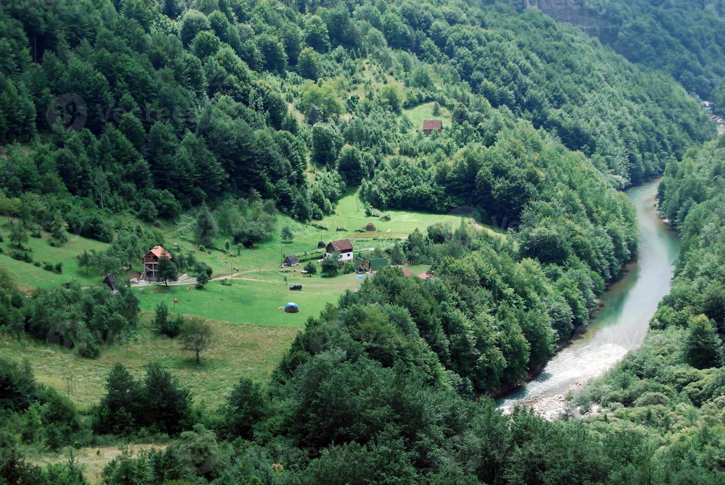 Green valley, village by the mountain river, aerial view photo