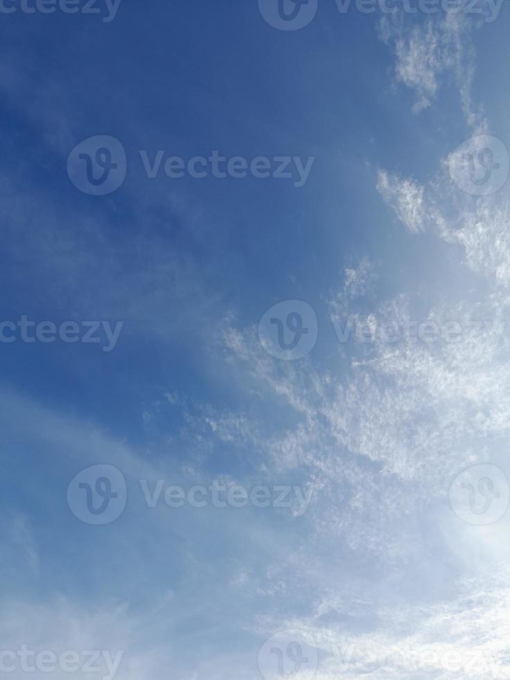 Beautiful white clouds on deep blue sky background. Large bright soft fluffy clouds are cover the entire blue sky. photo