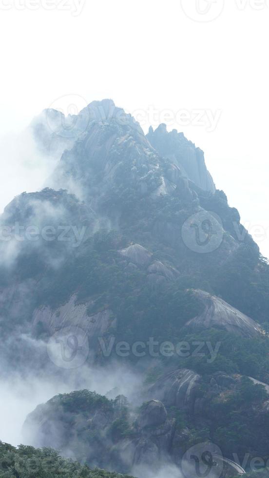 The beautiful mountains landscapes with the green forest and the erupted rock cliff as background in the countryside of the China photo