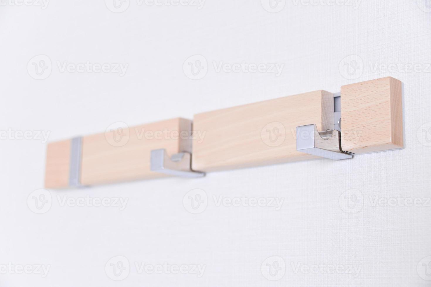 wooden hanger on white wall photo