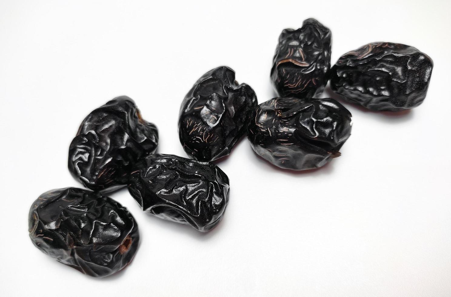 Close up of dried ajwa dates fruit isolated on white background photo