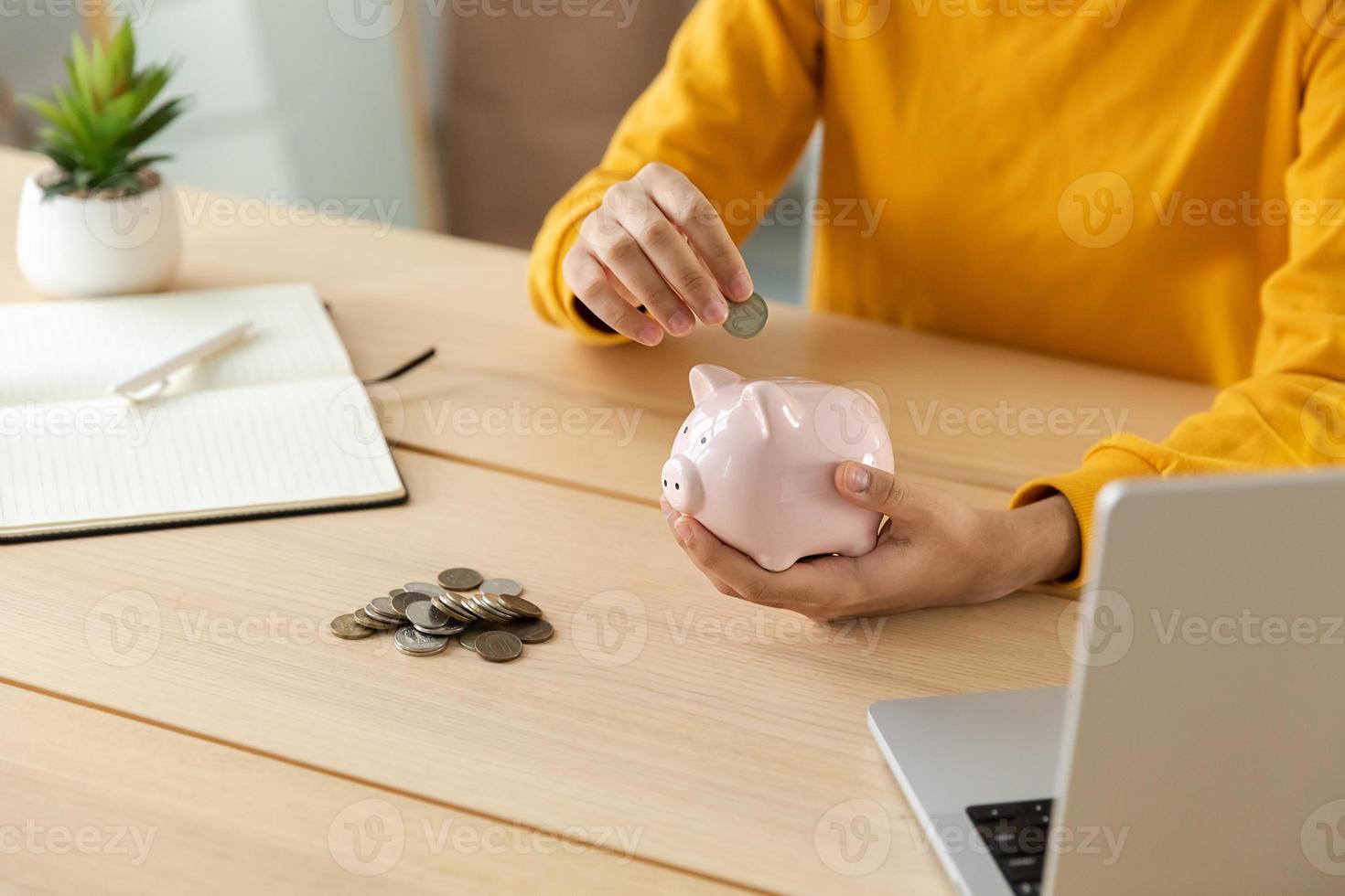 Saving money investment for future. Female woman hands holding pink piggy bank and putting money coin. Saving investment budget business wealth retirement financial money banking concept. photo