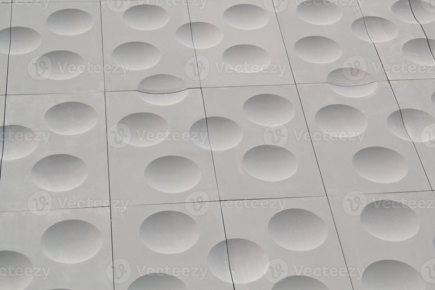 The close-up of grey detailed sphere texture reverse side of the plastic tile. Rough embossed lattice. Concept of design. Wall decoration interior. Relief balls geometric pattern. Flatlay, mock up photo