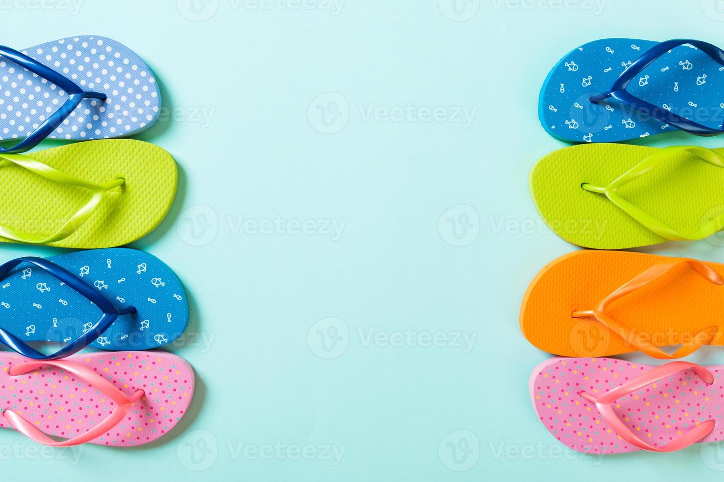 a lot of flip flop colored sandals, summer vacation on colored background, copy space top view photo