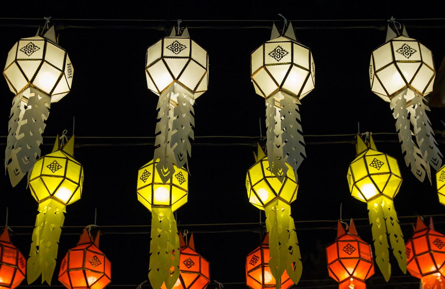 colorful hanging lanterns lighting on night sky in loy krathong festival at northern of thailand photo