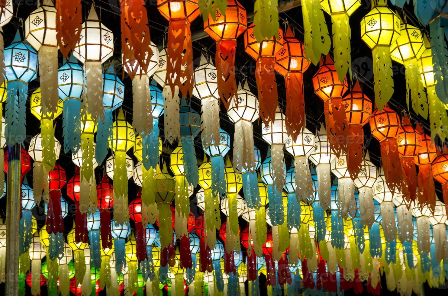 colorful hanging lanterns lighting on night sky in loy krathong festival at northern of thailand photo