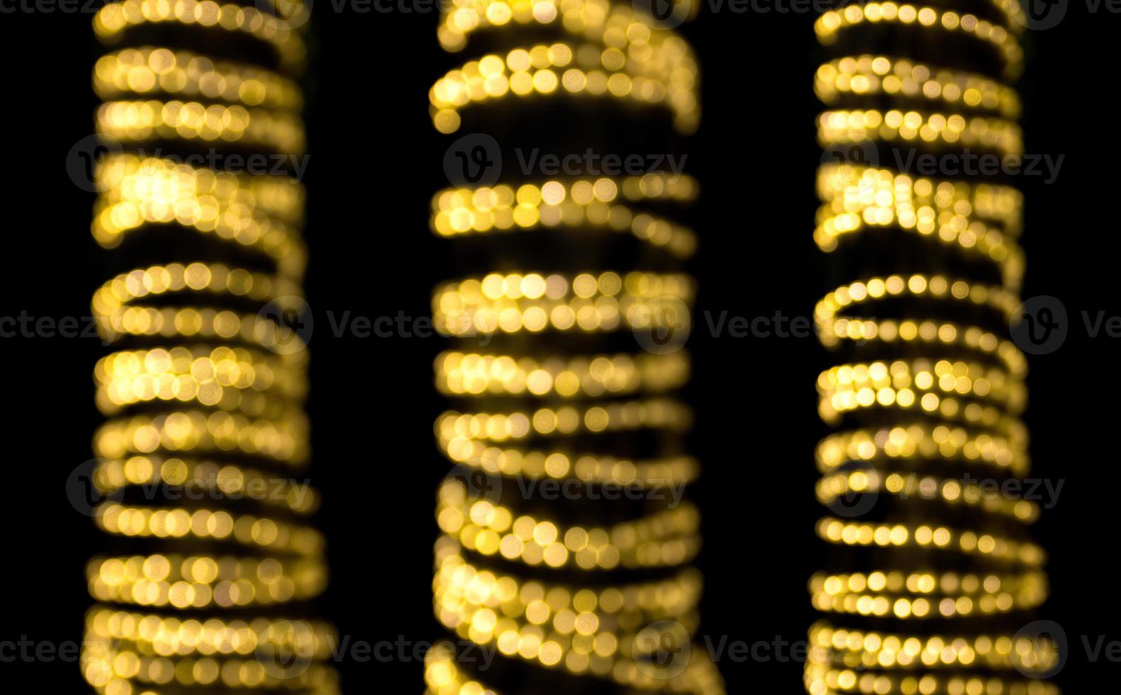 abstract golden bokeh light background, swivel shape design element, isolated on black background photo