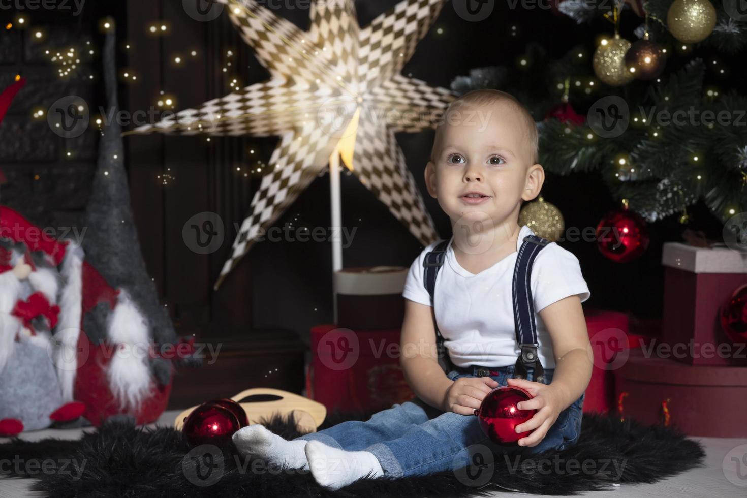 Happy baby under the Christmas tree. Christmas child photo