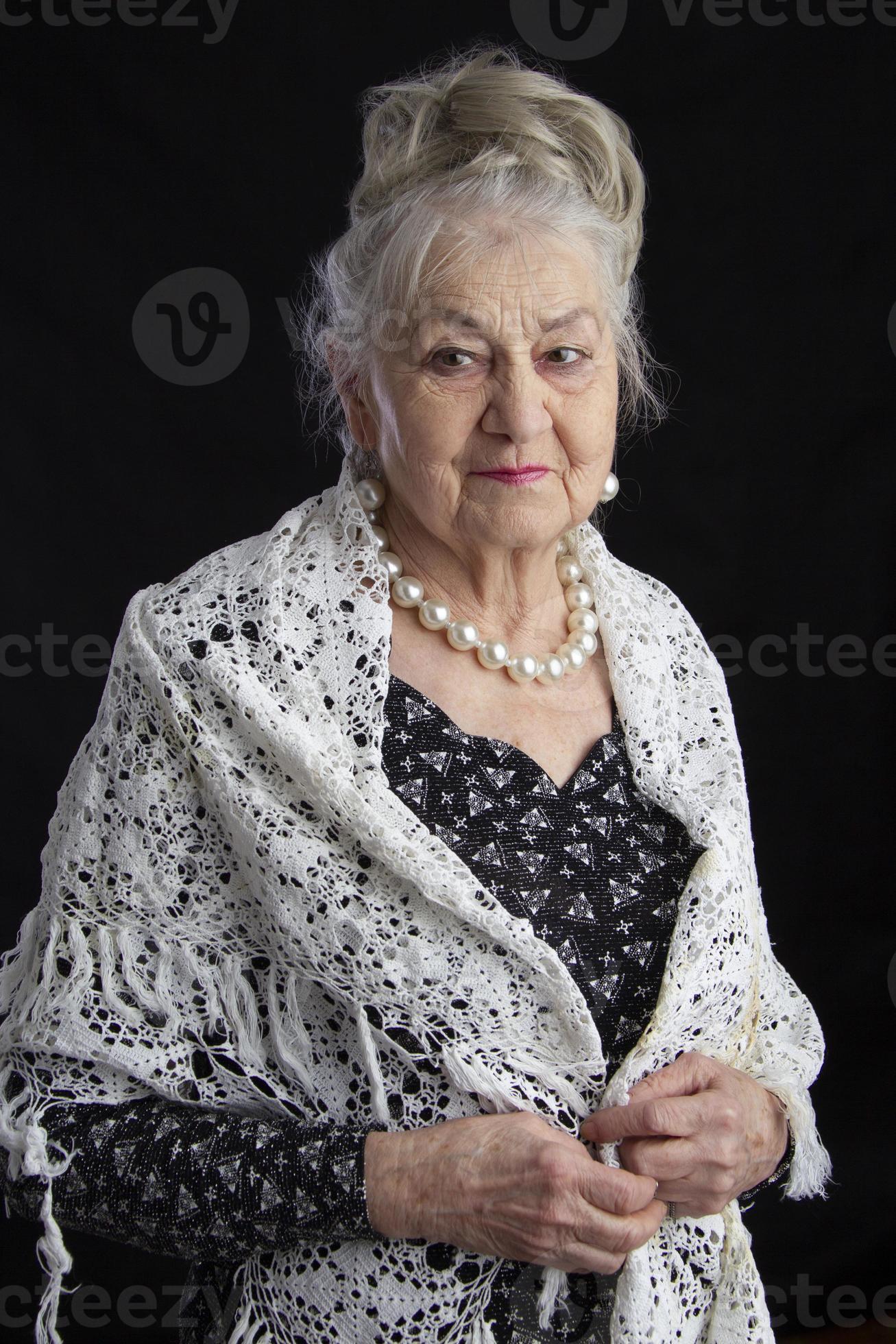 Portrait of a ninety year old woman. Beautiful old lady. Luxurious  grandmother on a black background. Elderly beauty. The gray-haired  well-groomed pensioner. 22120143 Stock Photo at Vecteezy