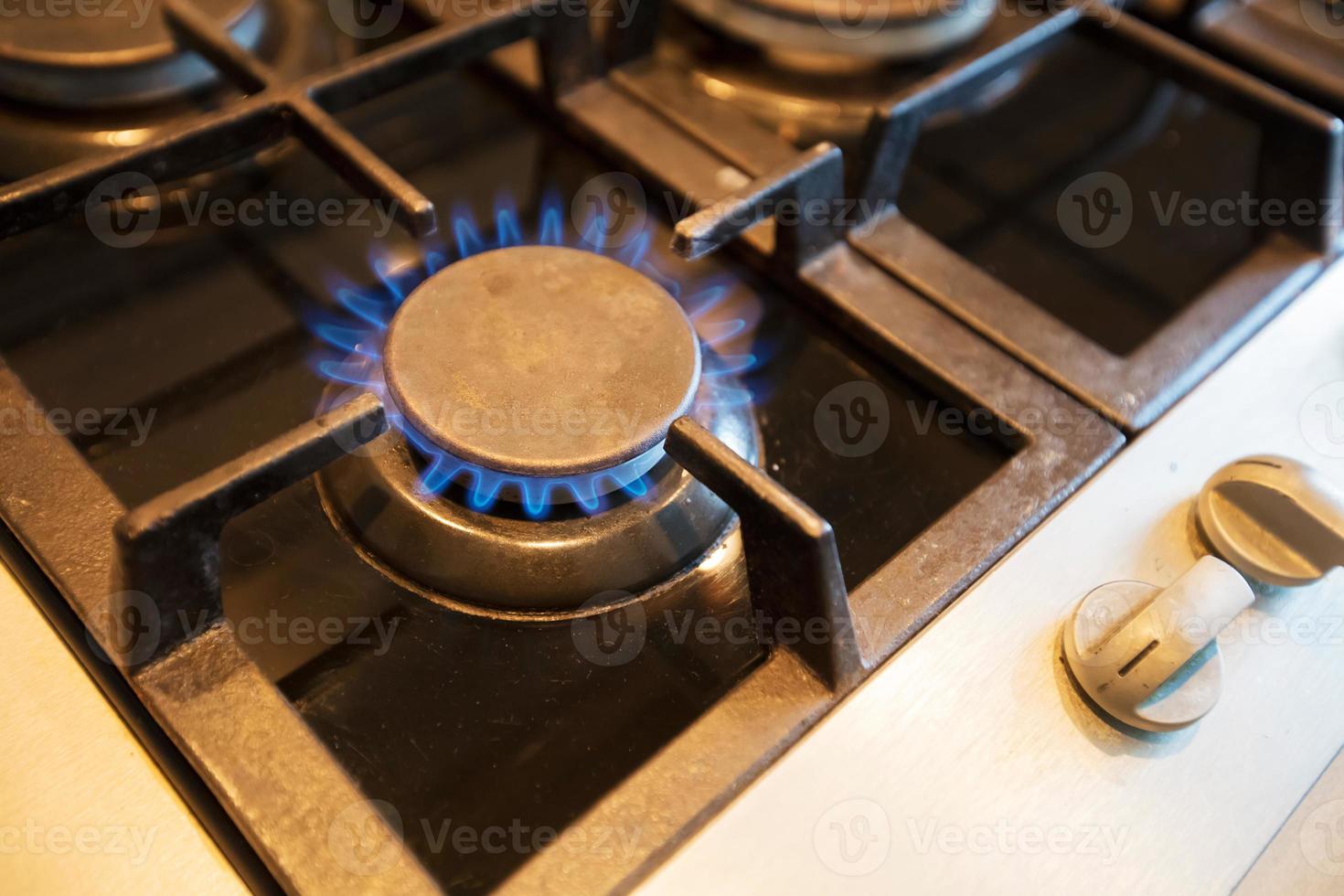 Gas stove burner with blue flame. Gas. photo