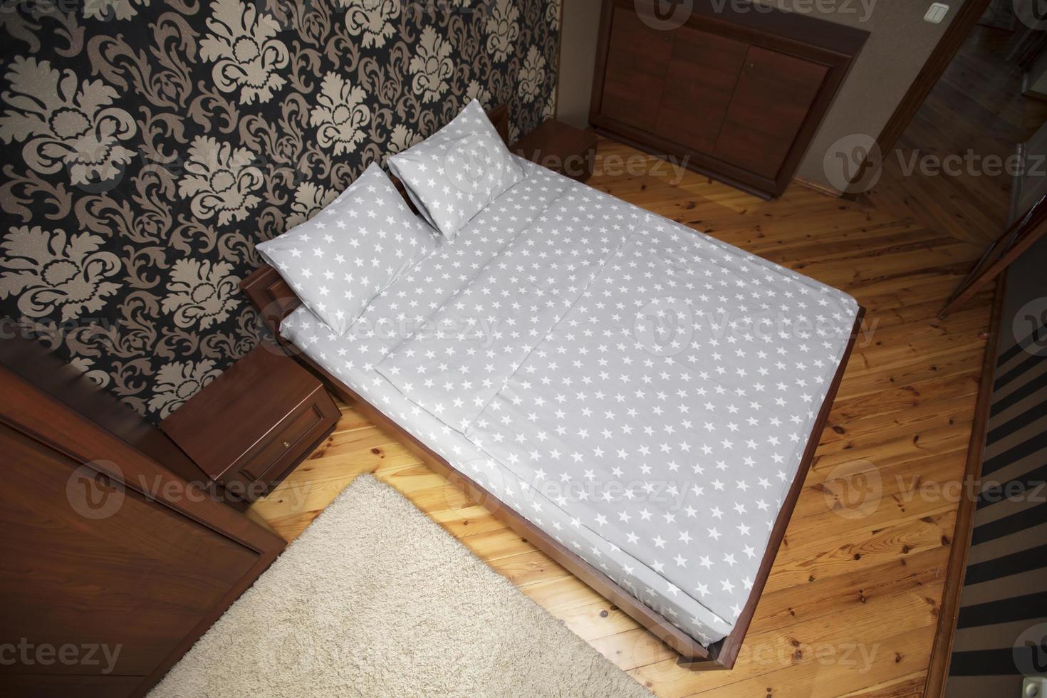 Interior of a small bedroom with a top view bed. photo