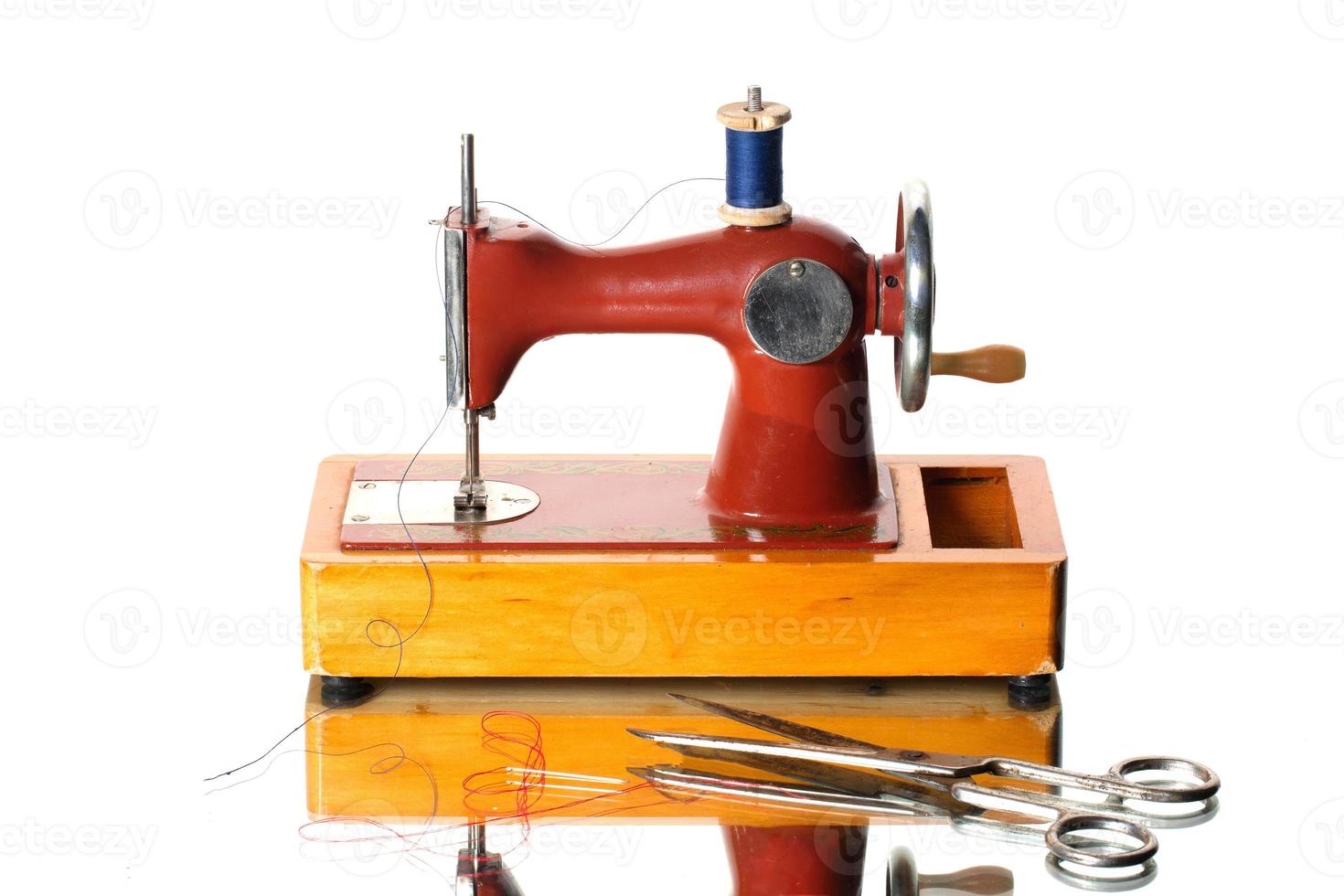 Retro sewing machine with scissors and bobbin. Children's Soviet sewing machine toy. photo