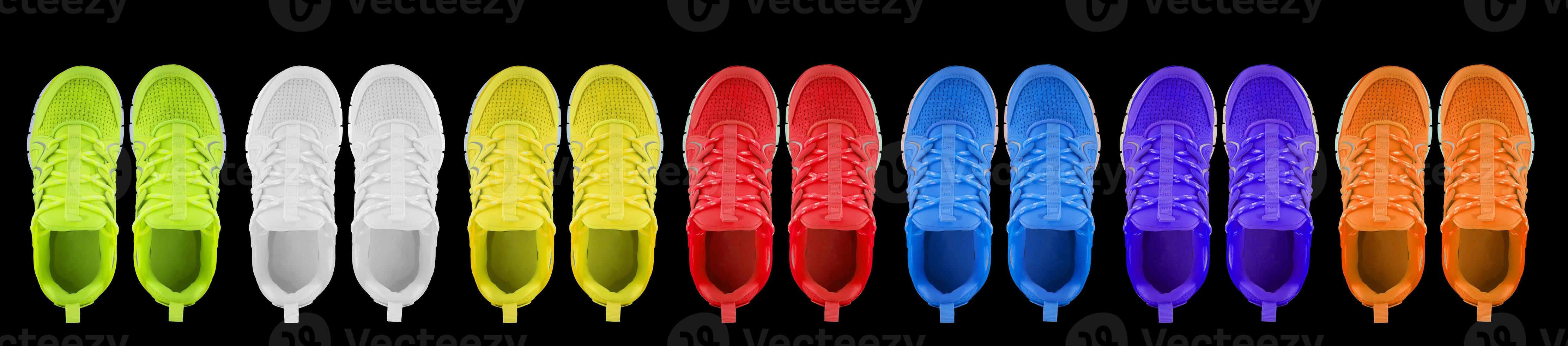 Sneakers in different colors on a black background. Seamless texture of multi-colored shoes. photo