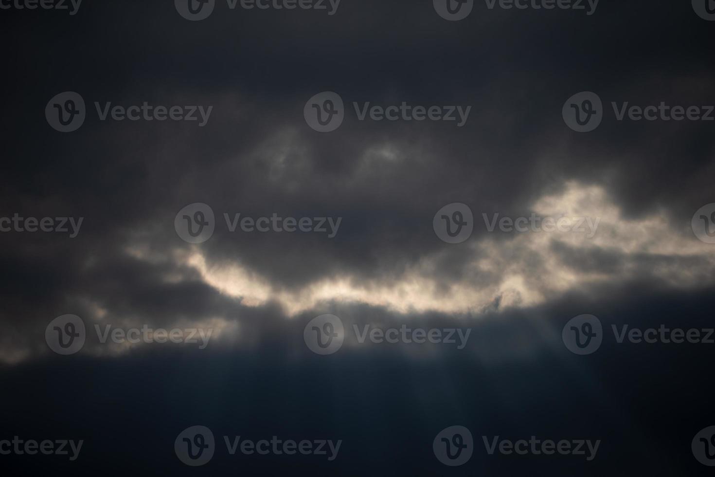 Dark sky with clouds and rays of the sun. Background cloudy day. photo