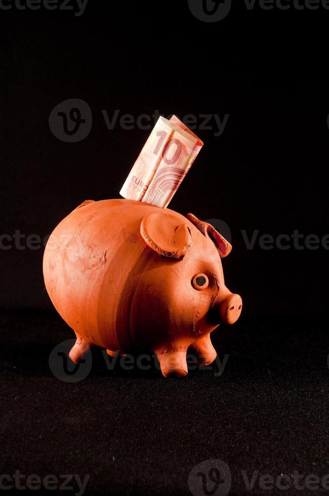 Piggy bank isolated on black background photo