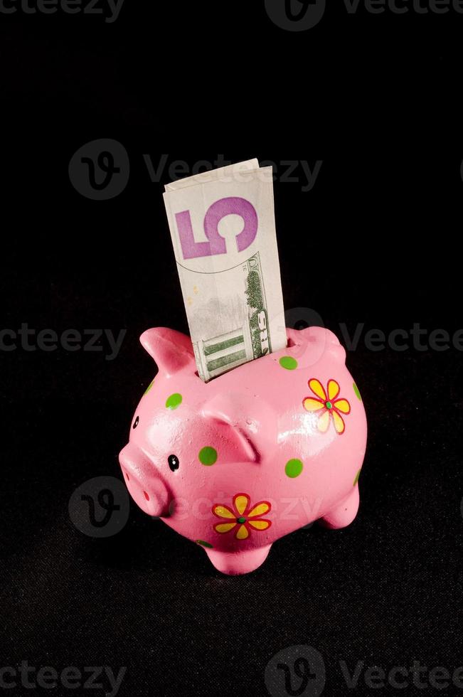 Piggy bank isolated on black background photo