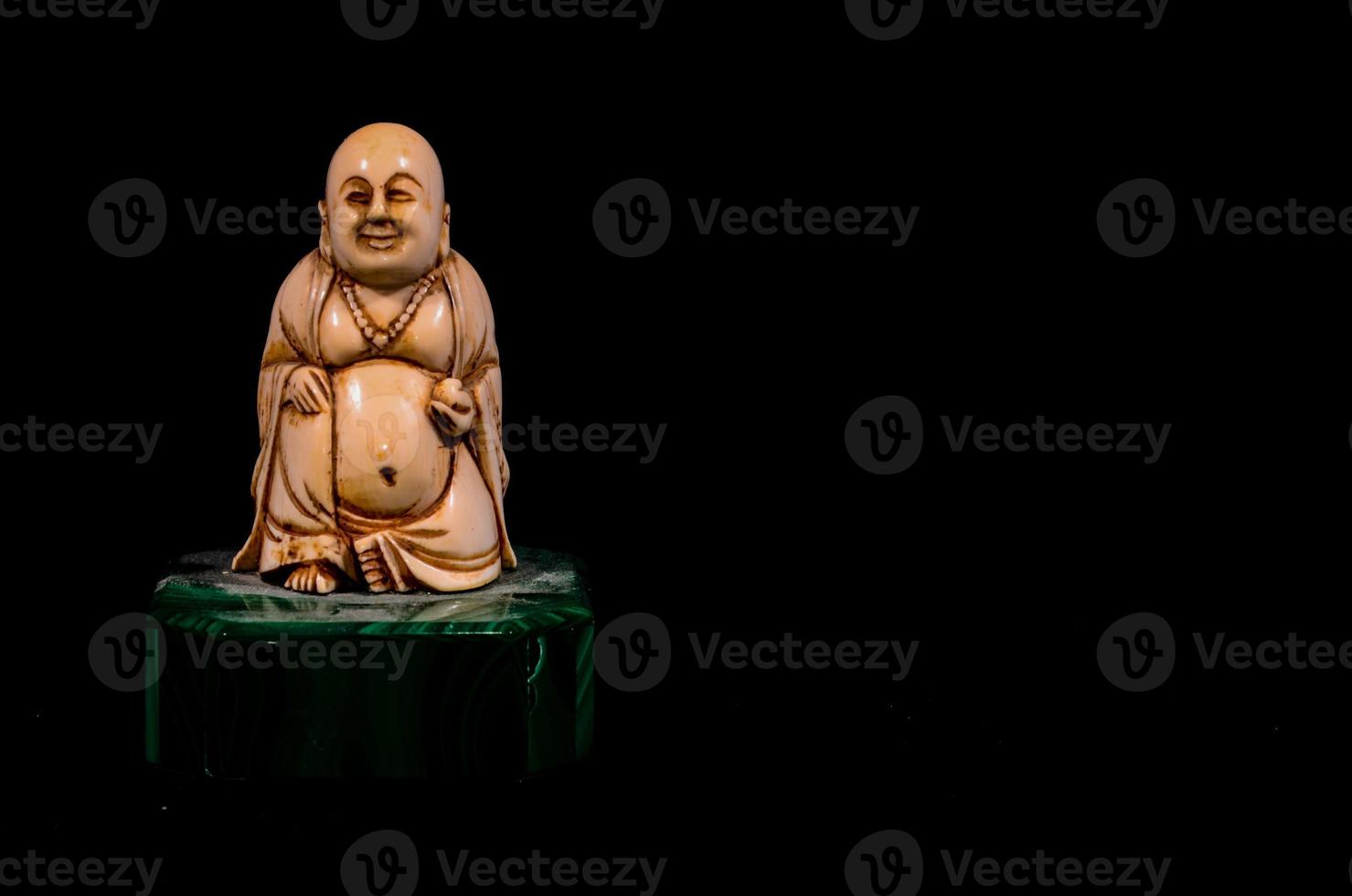 Buddha statue isolated on black background photo