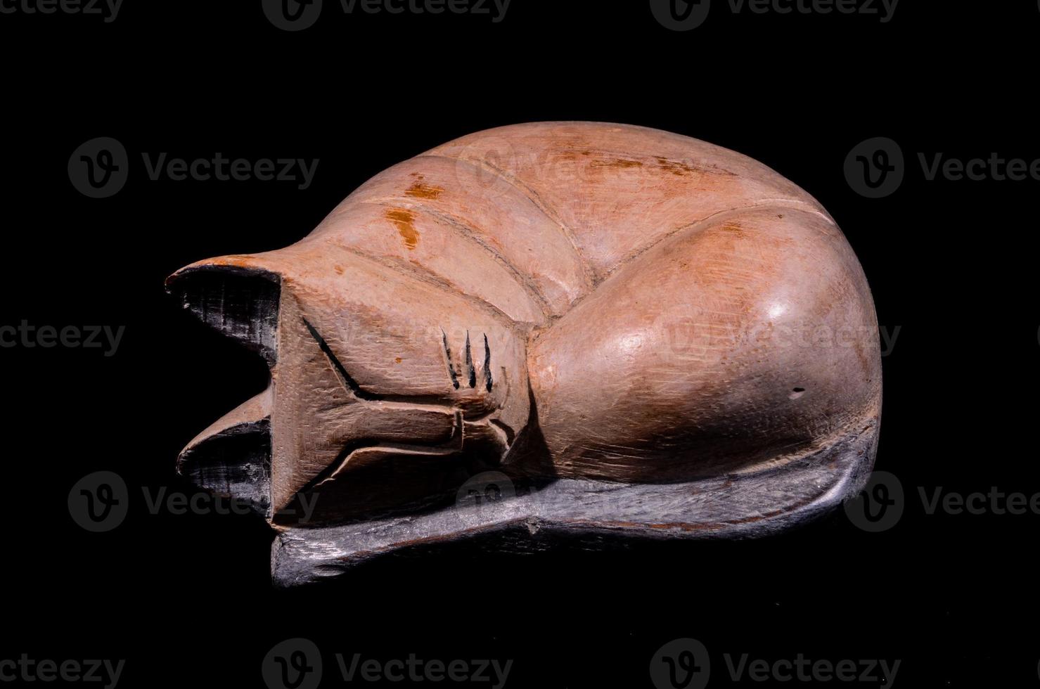 Cat sculpture isolated on black background photo
