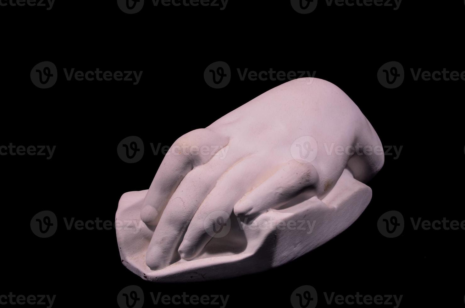 Hand sculpture isolated on black background photo