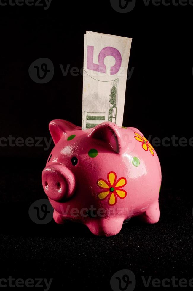 Piggy bank on dark background photo