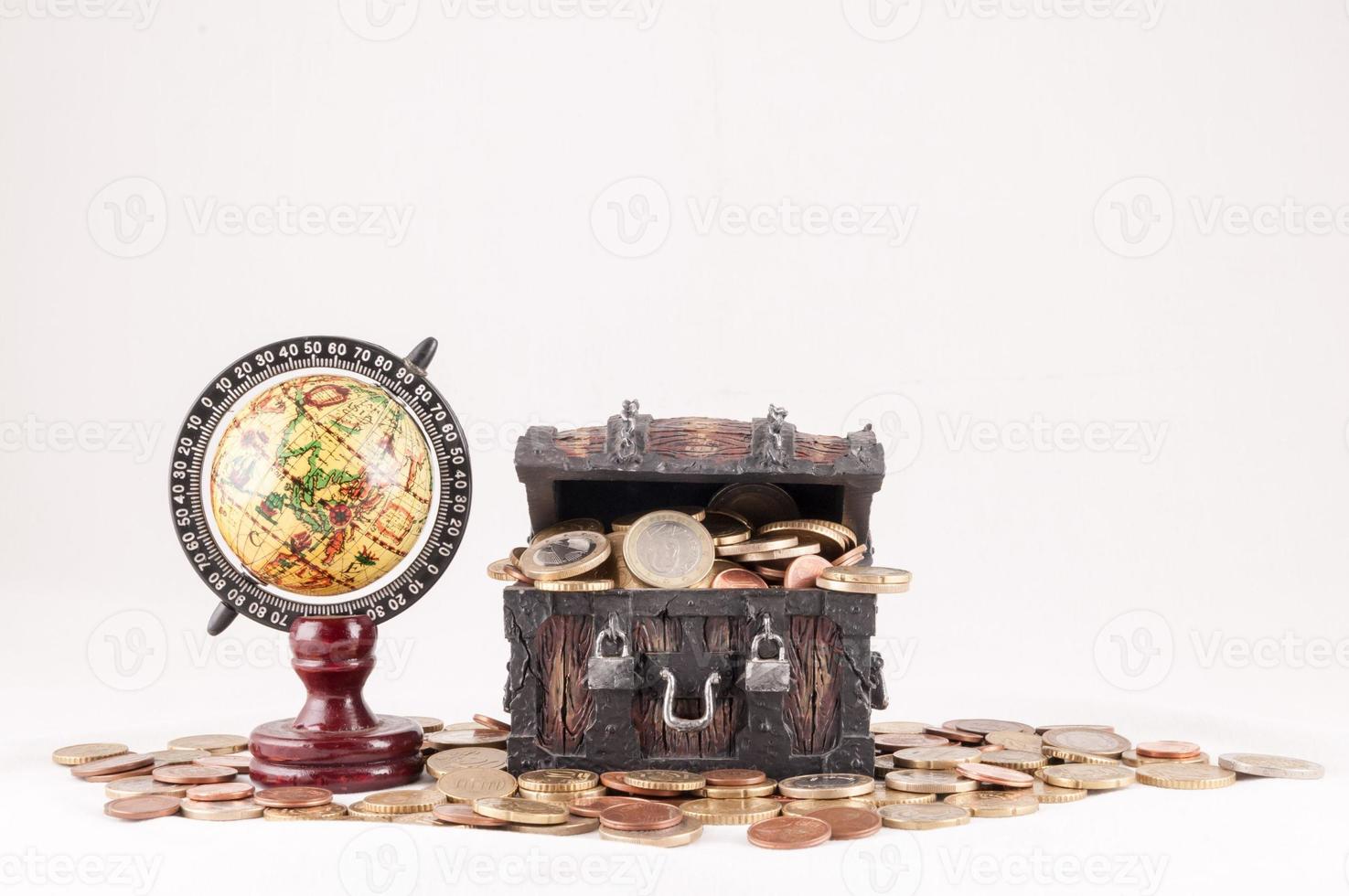 Globe, wood chest and coins photo