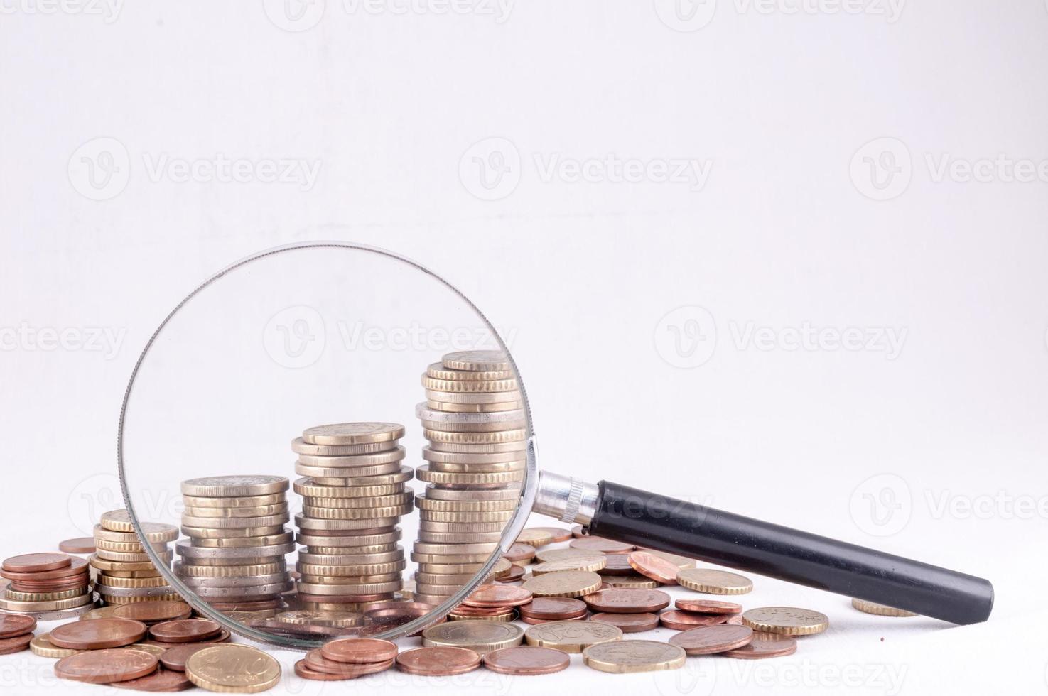 Magnifying glass and coins photo