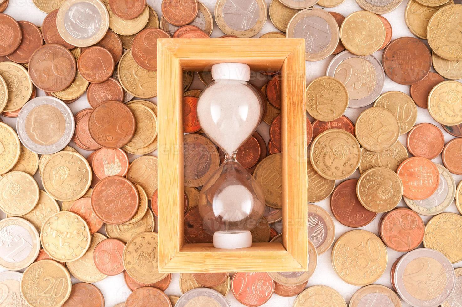 Hourglass and coins photo