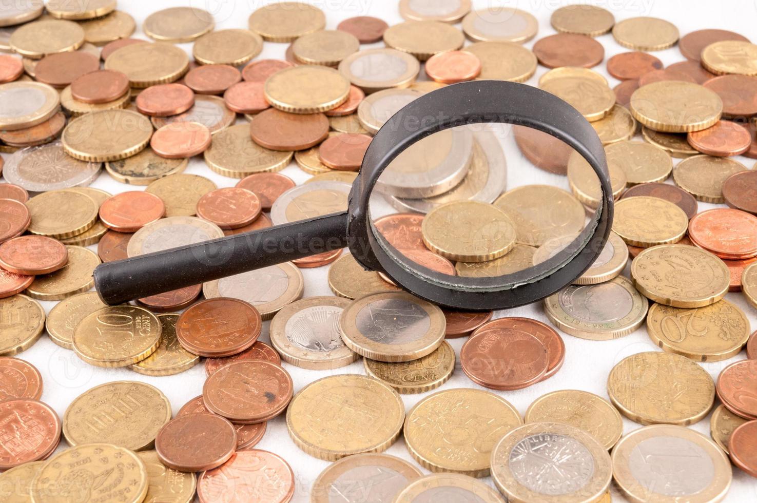 Magnifying glass with coins photo
