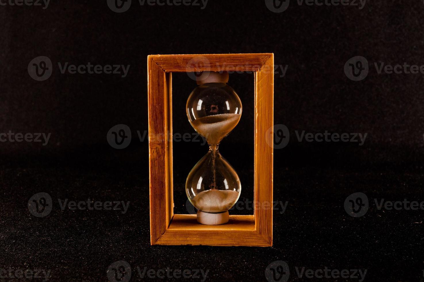 Hourglass on dark background photo