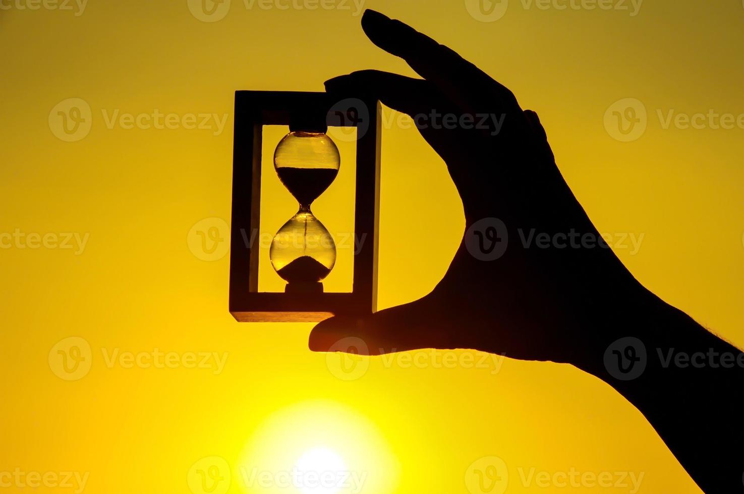 Hourglass and sunset photo