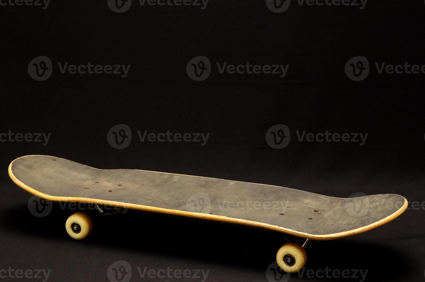 Skateboard on black background photo