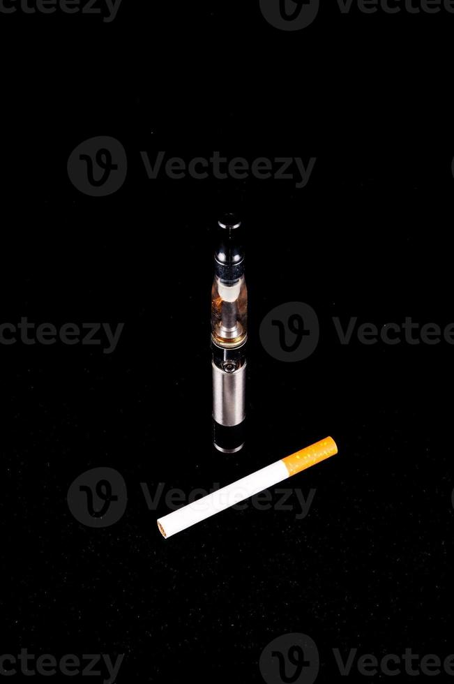 Electronic cigarette on black background photo
