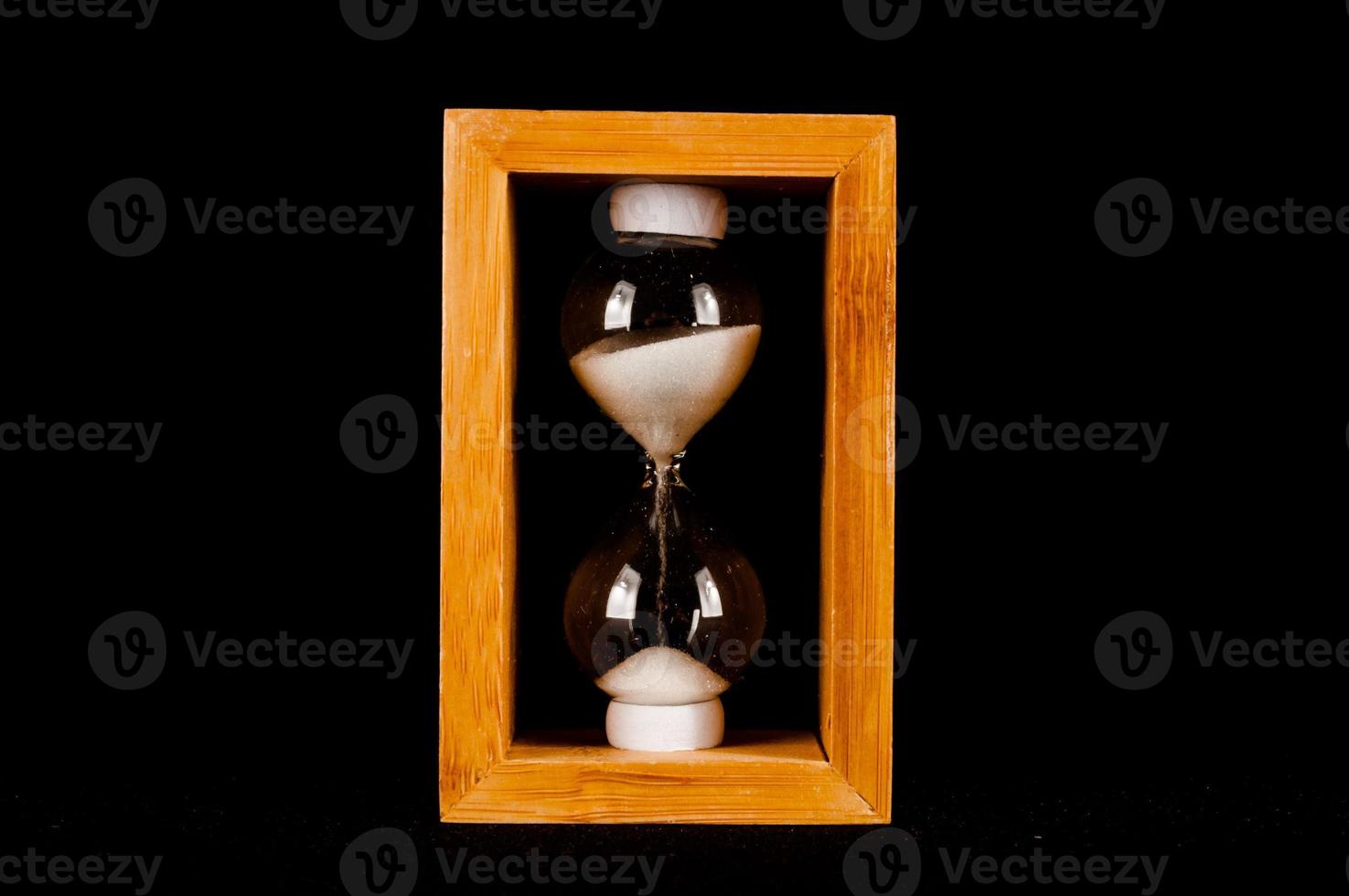 Hourglass on dark background photo